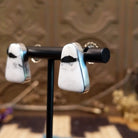 Sterling silver earrings with white buffalo stones set in bezels.