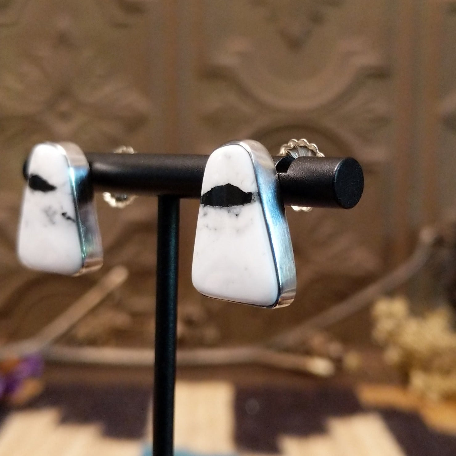Sterling silver earrings with white buffalo stones set in bezels.