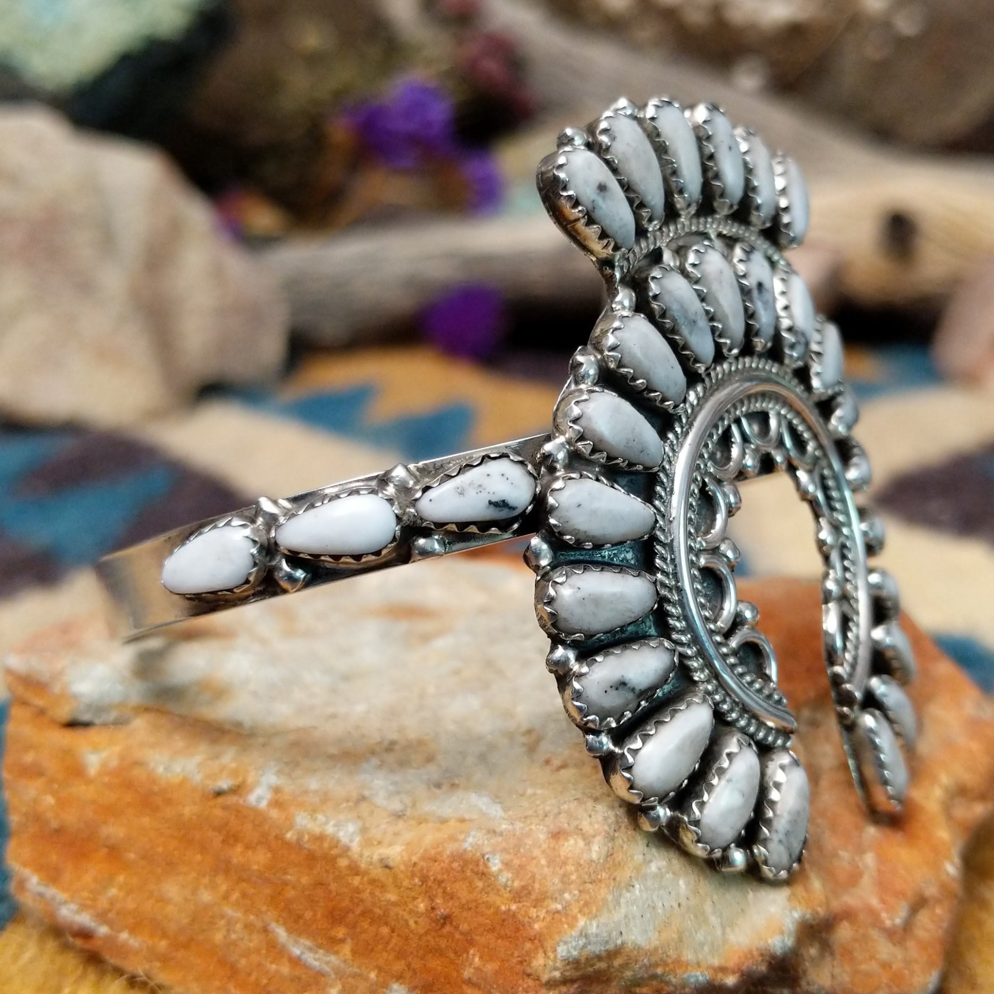 Handcrafted sterling silver Naja cuff by Zeta Begay featuring White Buffalo stones in a fan pattern with twisted rope detailing, silver bead accents, and traditional Navajo craftsmanship; side view.