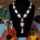 Southwestern-style Sterling Silver necklace and matching drop earrings featuring White Buffalo stones with natural black and gray matrix.