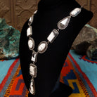 Southwestern-style Sterling Silver necklace featuring White Buffalo stones with natural black and gray matrix; side view.
