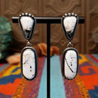 Southwestern-style Sterling Silver drop earrings featuring White Buffalo stones with natural black and gray matrix.