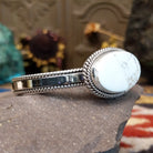 Sterling silver cuff featuring a White Buffalo stone set in a twisted rope bezel.