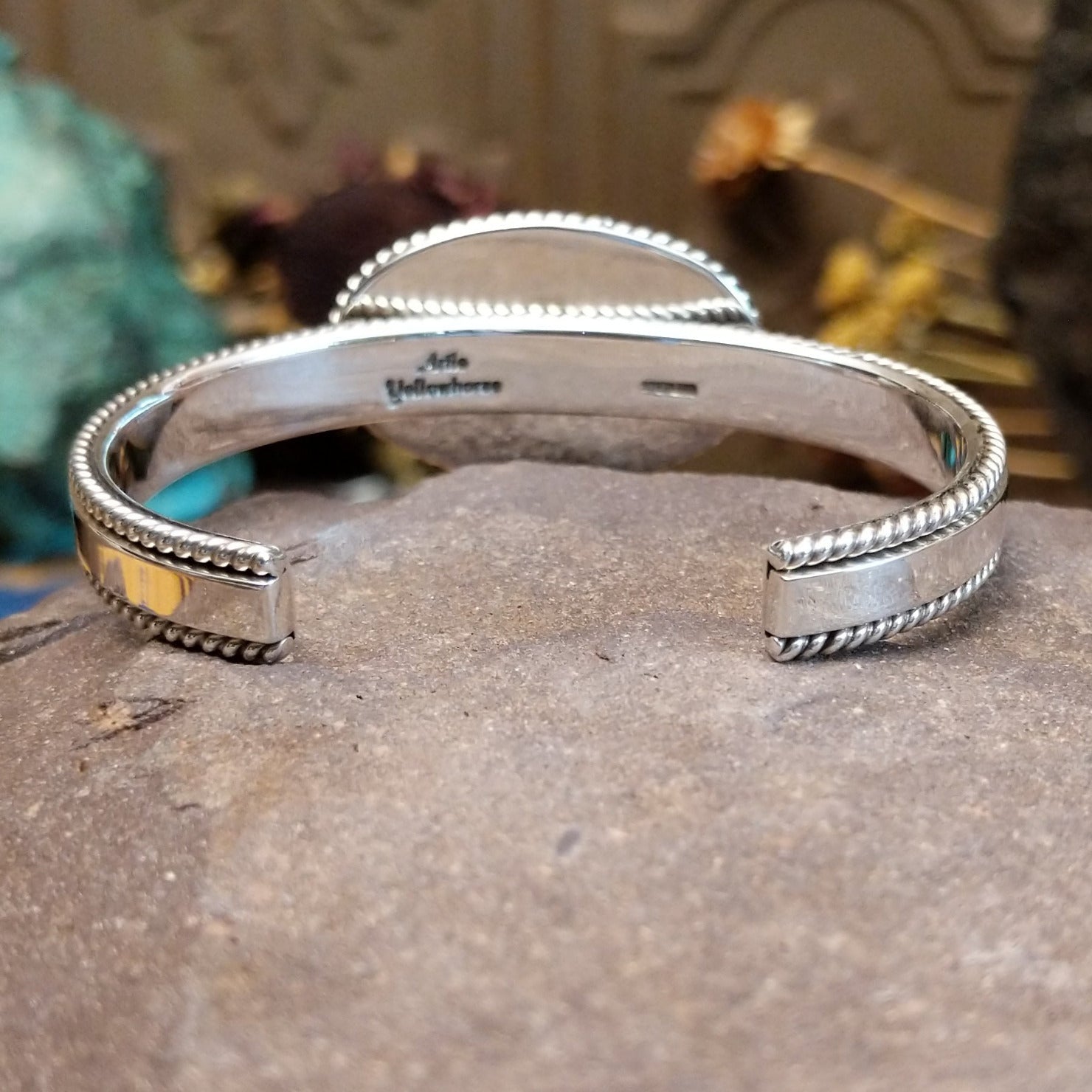 Sterling silver cuff featuring a White Buffalo stone set in a twisted rope bezel.