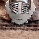 Close-up of the artist's stamped signature.