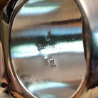 Close-up of the artisan's stamped signature.