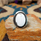 White Buffalo sterling silver ring by Alfred Martinez with an oval white stone and natural black veining.