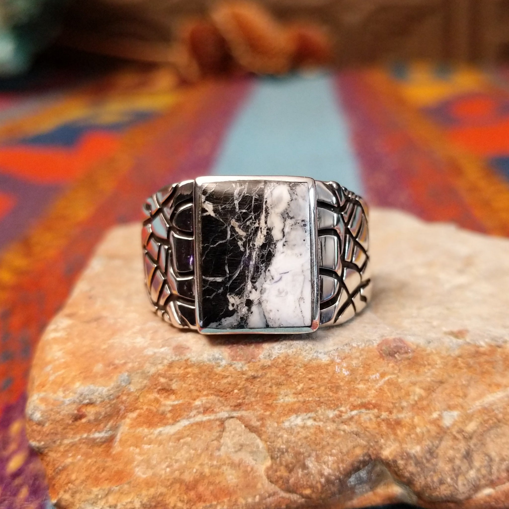 White Buffalo Ring by Terry Wood featuring a rectangular black-and-white stone with dramatic natural veining, set in polished silver with an intricate geometric openwork band.