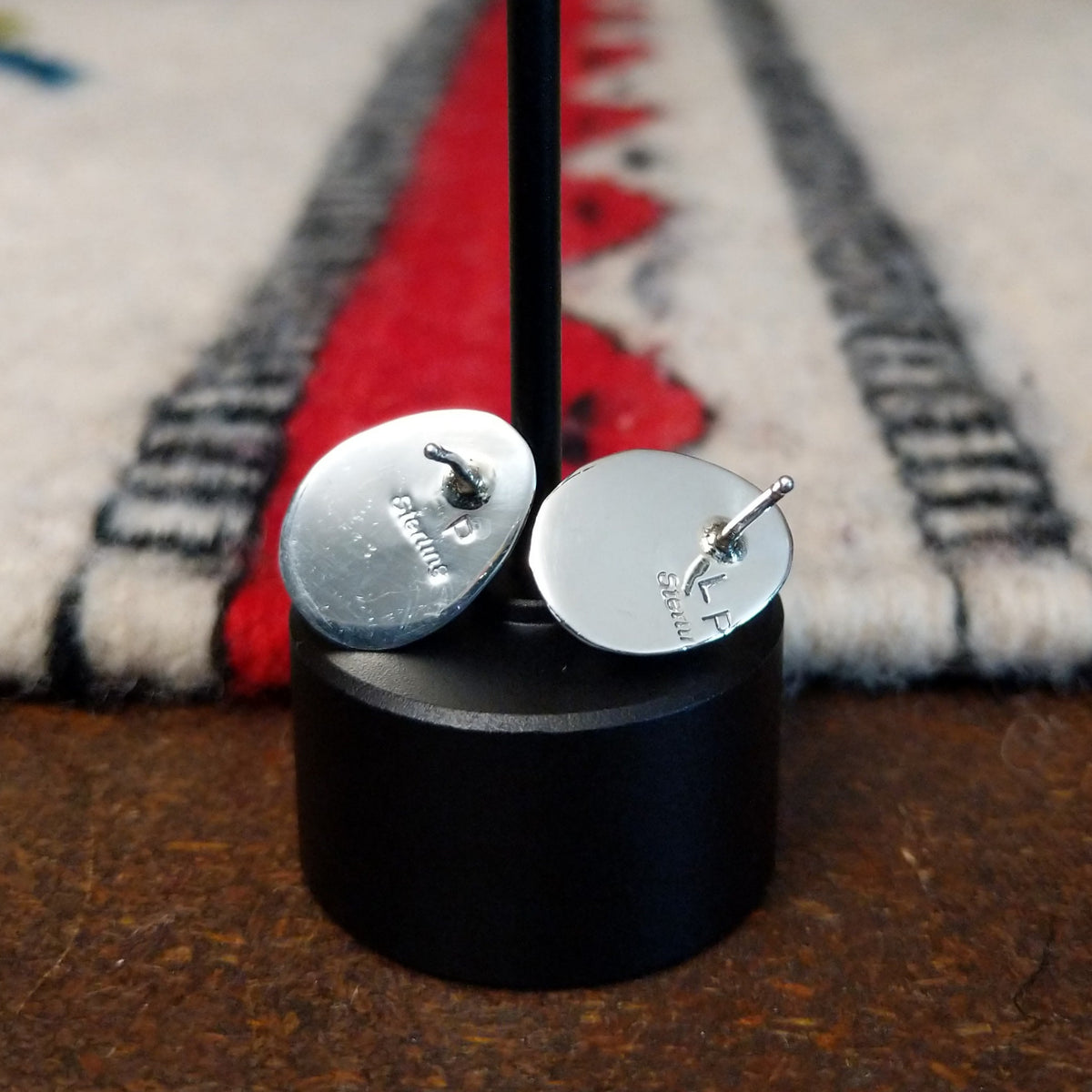 Whitewater turquoise stud earrings by L.P. featuring teardrop-shaped turquoise stones with natural matrix set in polished sterling silver with twisted rope detailing; artisan and Sterling Silver stamp.