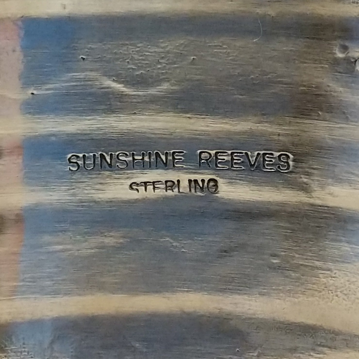 Close up of the artist's stamped signature.