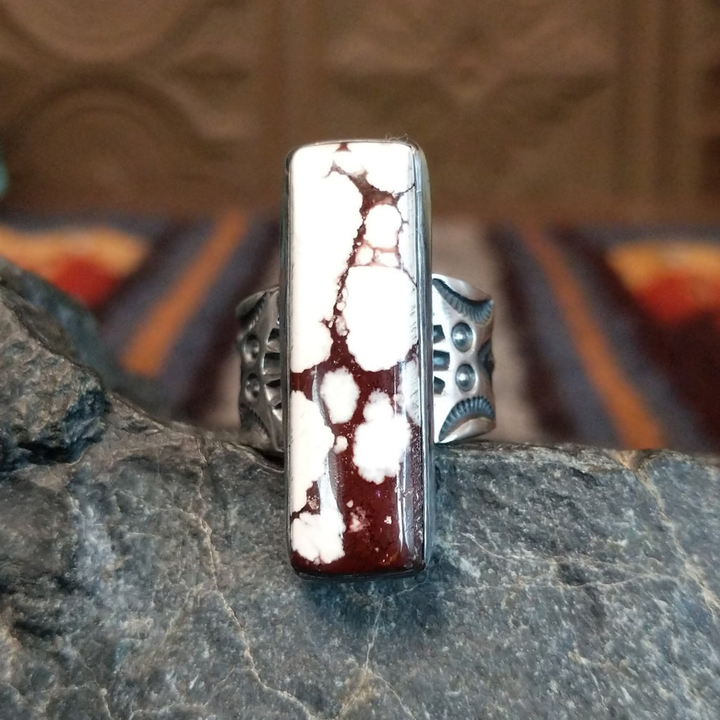 The wild horse stone is set in a smooth bezel with an ornate band.