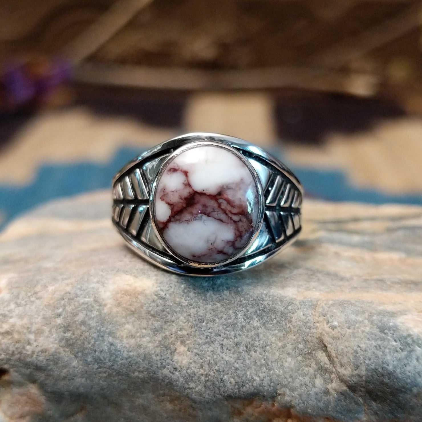 Sterling silver ring features wild horse stones set in round bezel and stamping on the band.
