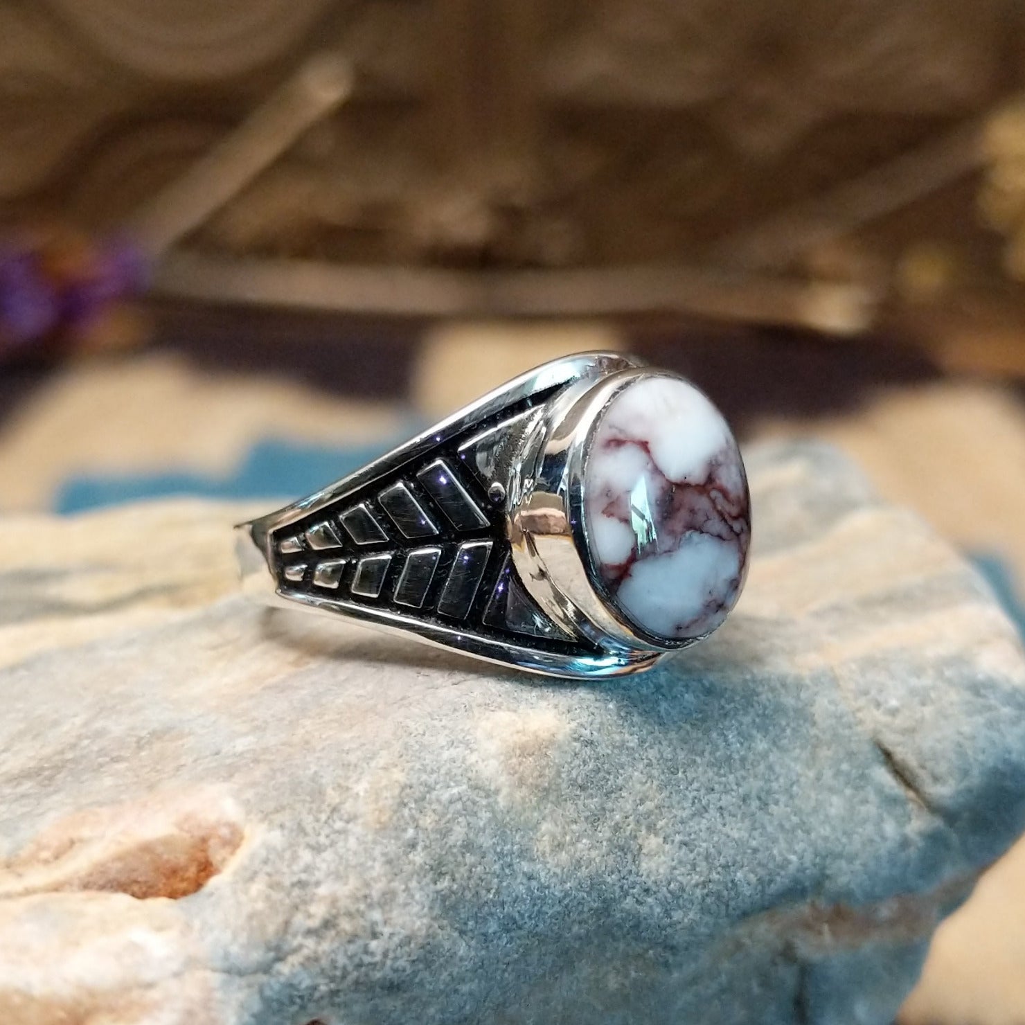 Sterling silver ring features wild horse stones set in round bezel and stamping on the band.