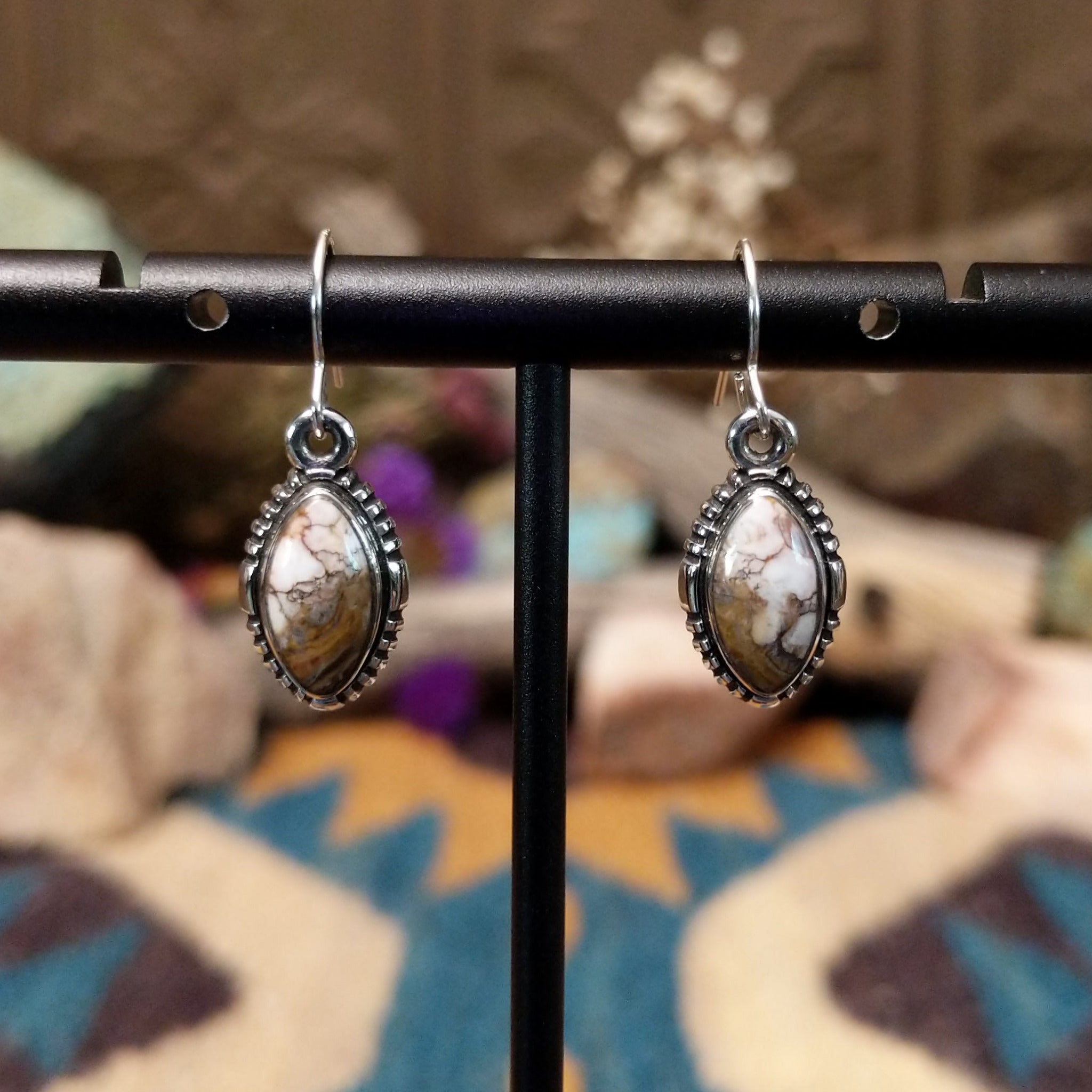Handcrafted sterling silver navette earrings featuring natural Wild Horse stone with creamy white and rich brown patterns, accented by detailed silver beadwork and French hook ear wires.