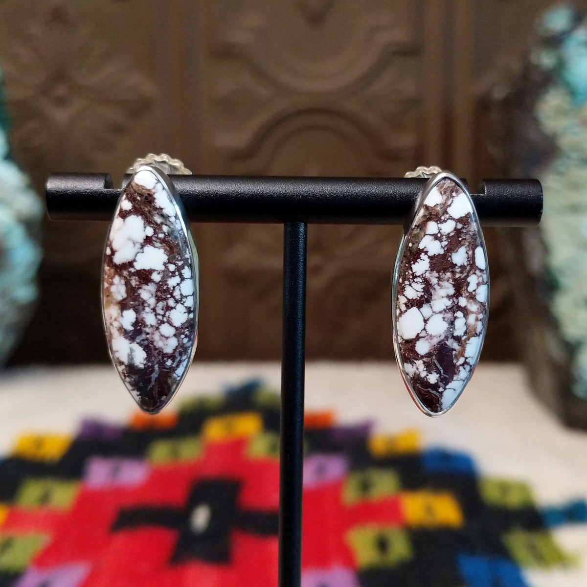 Wild Horse Earrings by Diane Wylie featuring elongated navette-shaped stones with white and reddish-brown matrix patterns set in smooth silver bezels.
