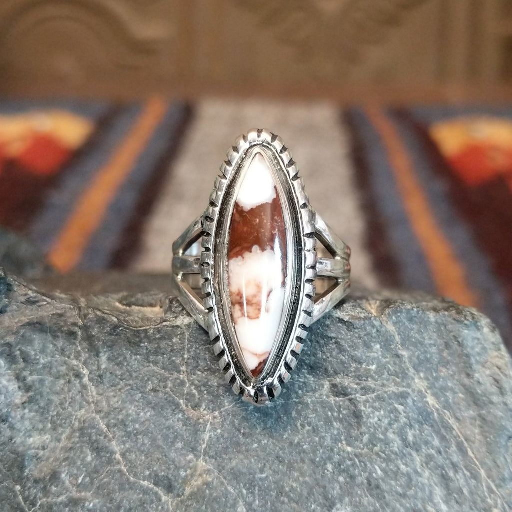 A wild horse stone within a sterling silver navette ring, framed by a serrated edge.