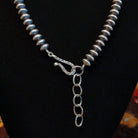 A sterling silver clasp with a minor adjustable chain.