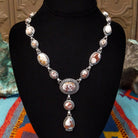 Wild Horse Sterling Silver necklace by Mary Ellen, featuring natural white, cream, brown, and reddish matrix stones in an intricate handcrafted design.
