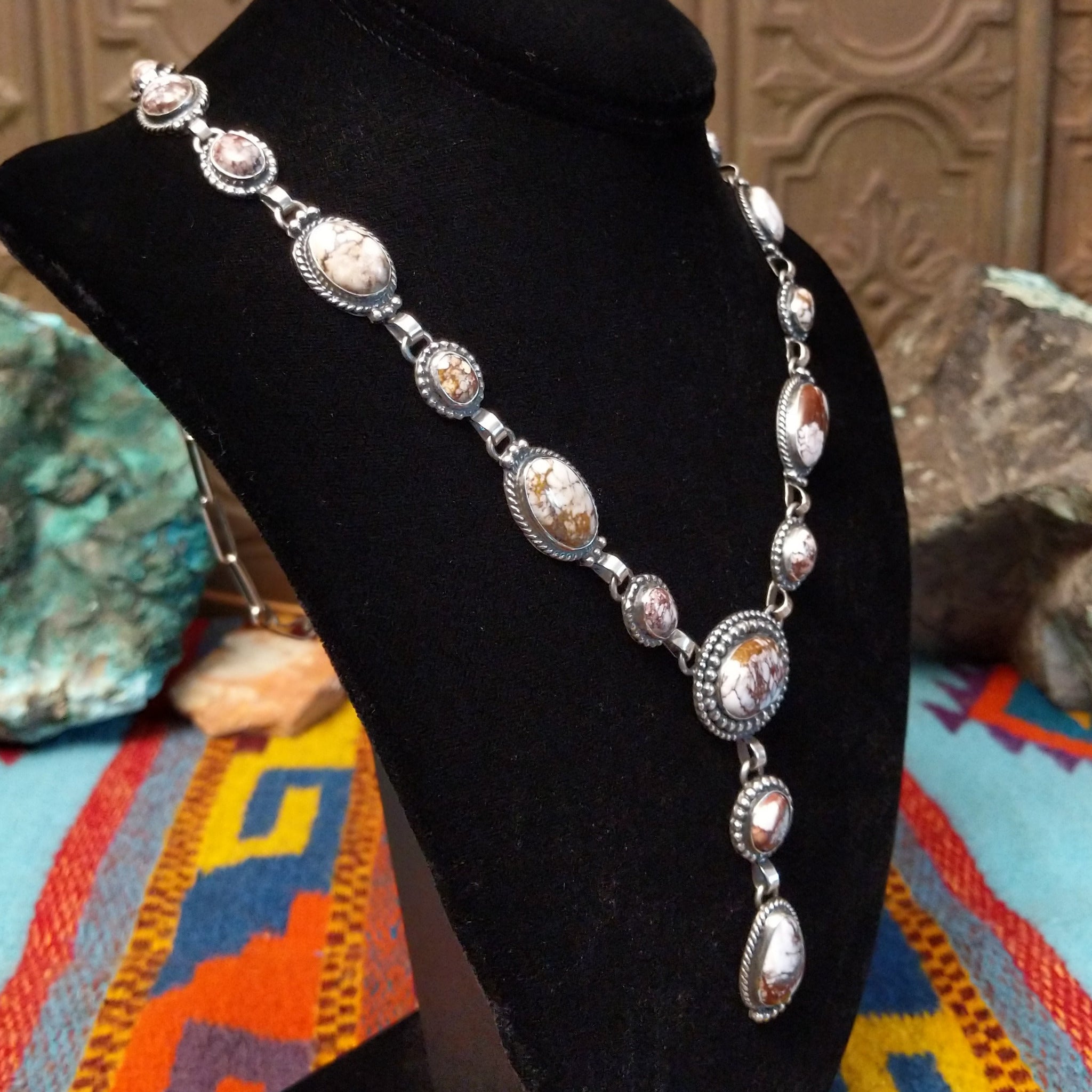 Wild Horse Sterling Silver necklace and  by Mary Ellen, featuring natural white, cream, brown, and reddish matrix stones in an intricate handcrafted design; side view.