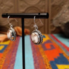 Wild Horse Sterling Silver earrings by Mary Ellen, featuring natural white, cream, brown, and reddish matrix stones in an intricate handcrafted design; side view/