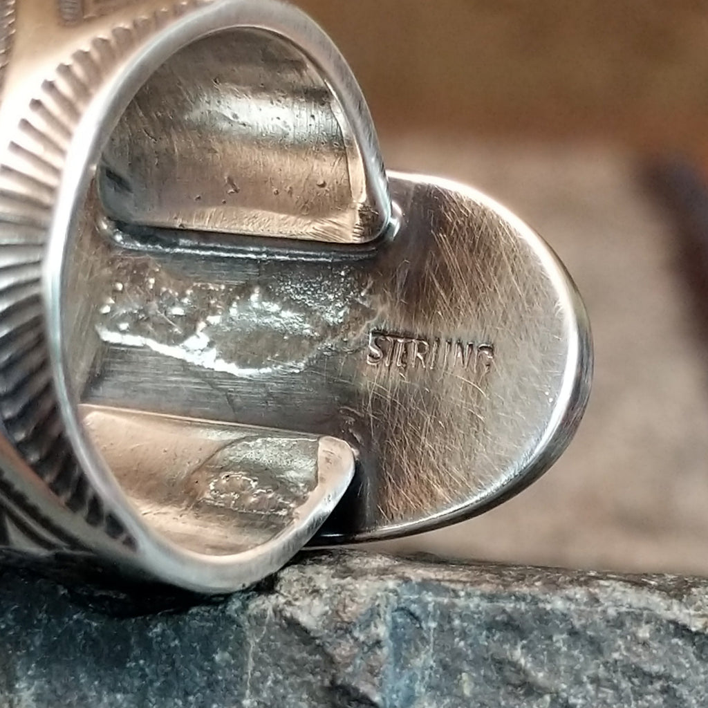 The sterling silver stamp is found on the underside of the bezel.