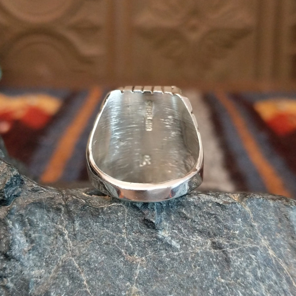 The polished sterling silver band is tapered toward the center.