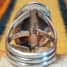 Rear view of a sterling silver Wild Horse stone ring by Terry Wood showing the open triple split-shank band, smooth setting back, and artist's stamped signature.
