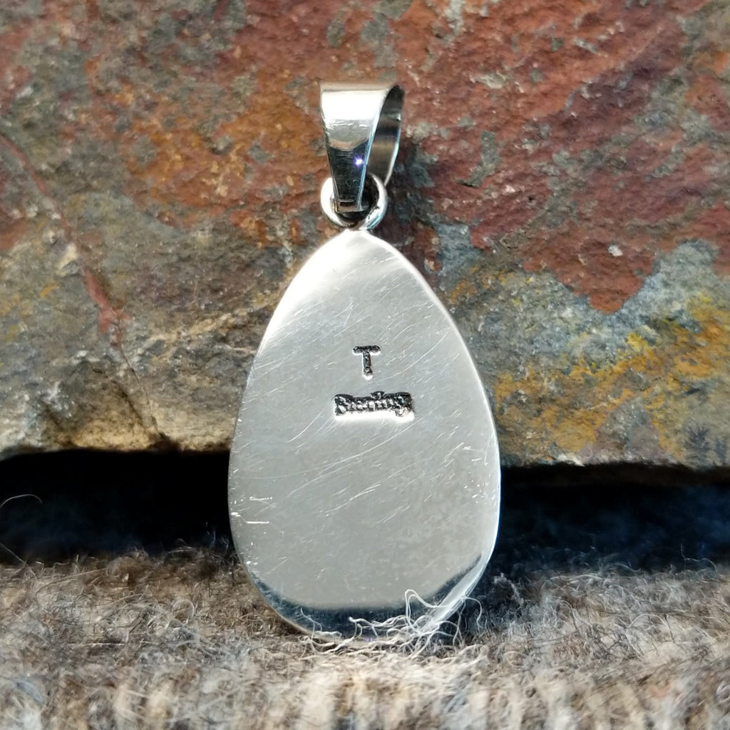 The back features the artist's initial and stamp.