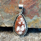 Wild horse stone set in a teardrop pendant with incised edges.