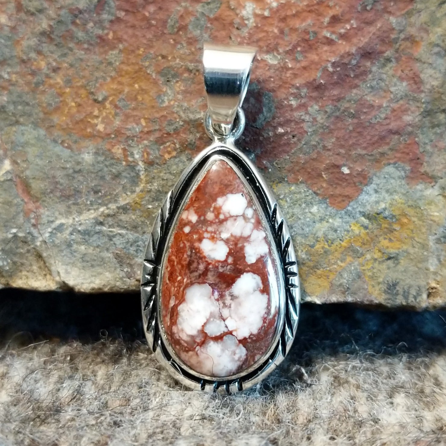 Wild horse stone set in a teardrop pendant with incised edges.