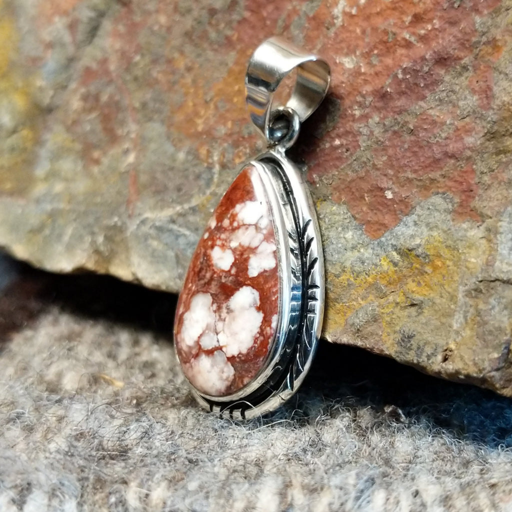Wild horse stone set in a teardrop pendant with incised edges.