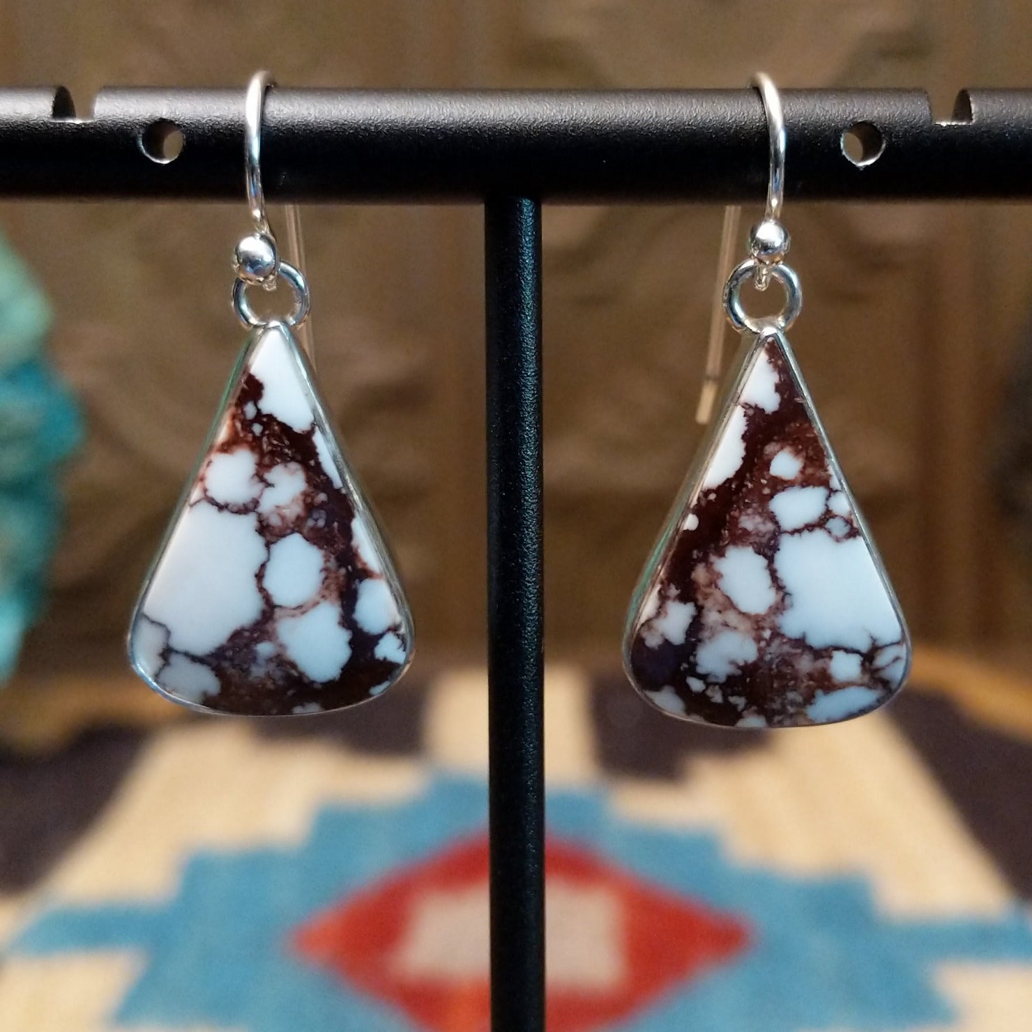 Sterling silver earrings featuring wild horse stones set in a triangular bezel.
