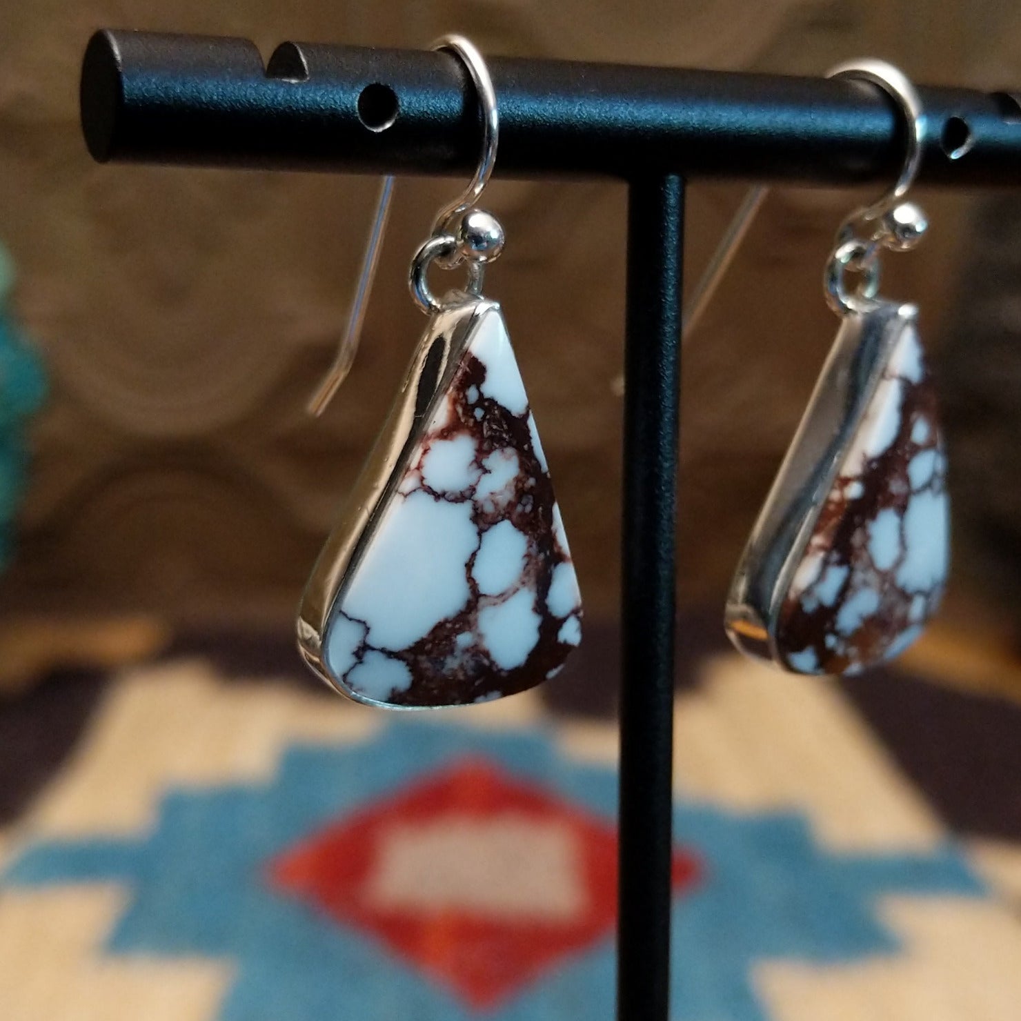 Sterling silver earrings featuring wild horse stones set in a triangular bezel.