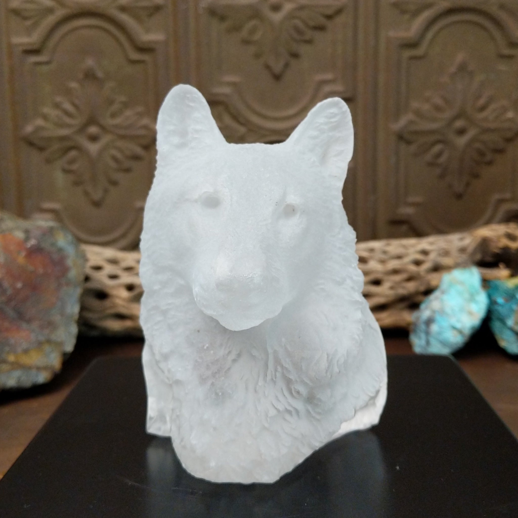 A frosted Lucite sculpture shaped like a wolf's head.