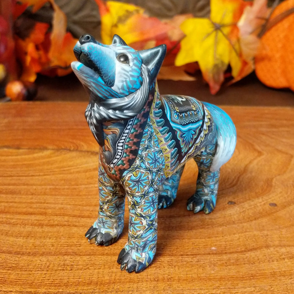 Polymer clay used to create a standing wolf with geometric and floral designs on its body.