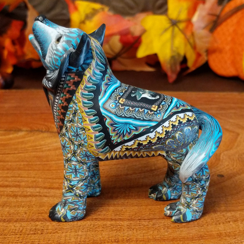 Polymer clay used to create a standing wolf with geometric and floral designs on its body.