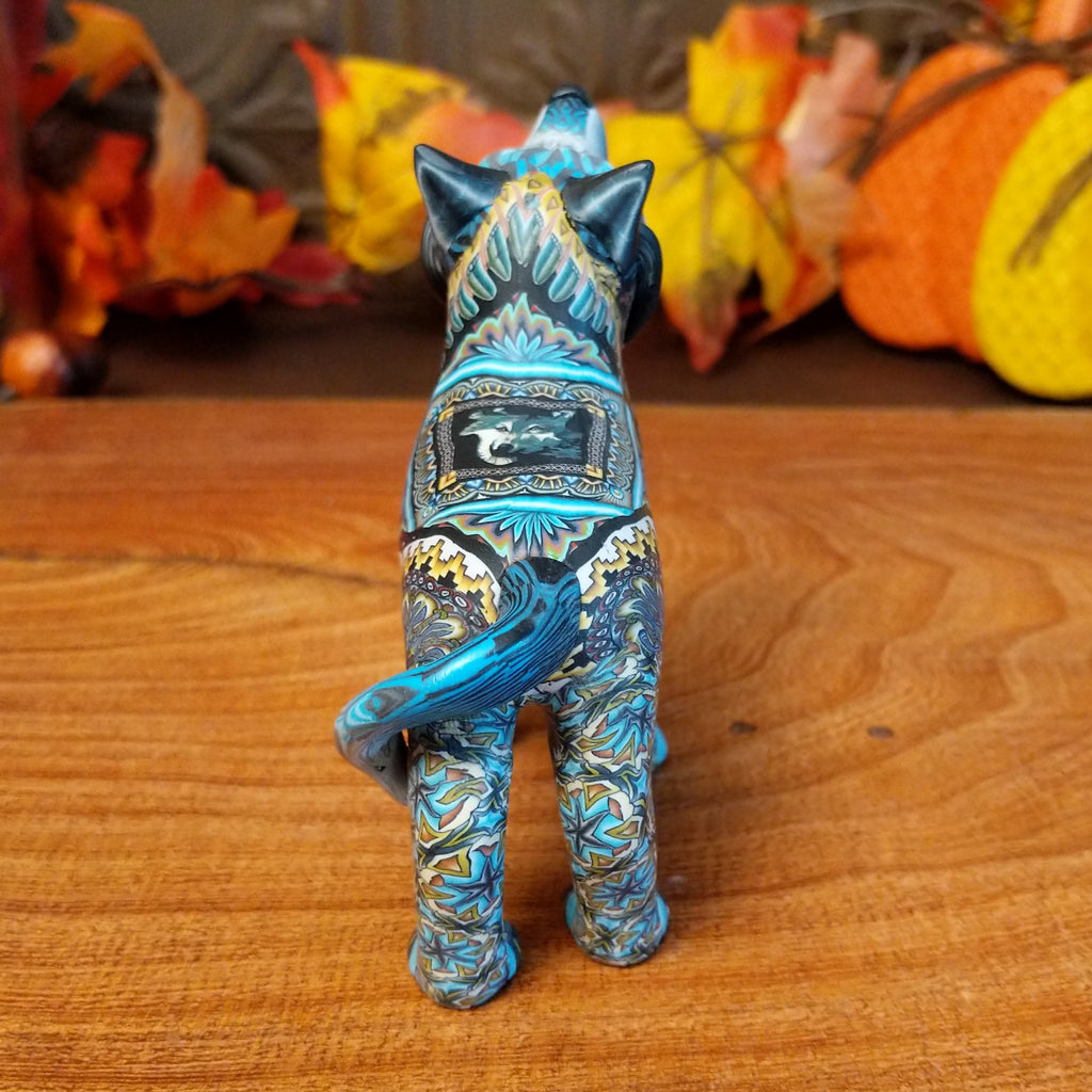 Polymer clay used to create a standing wolf with geometric and floral designs on its body.