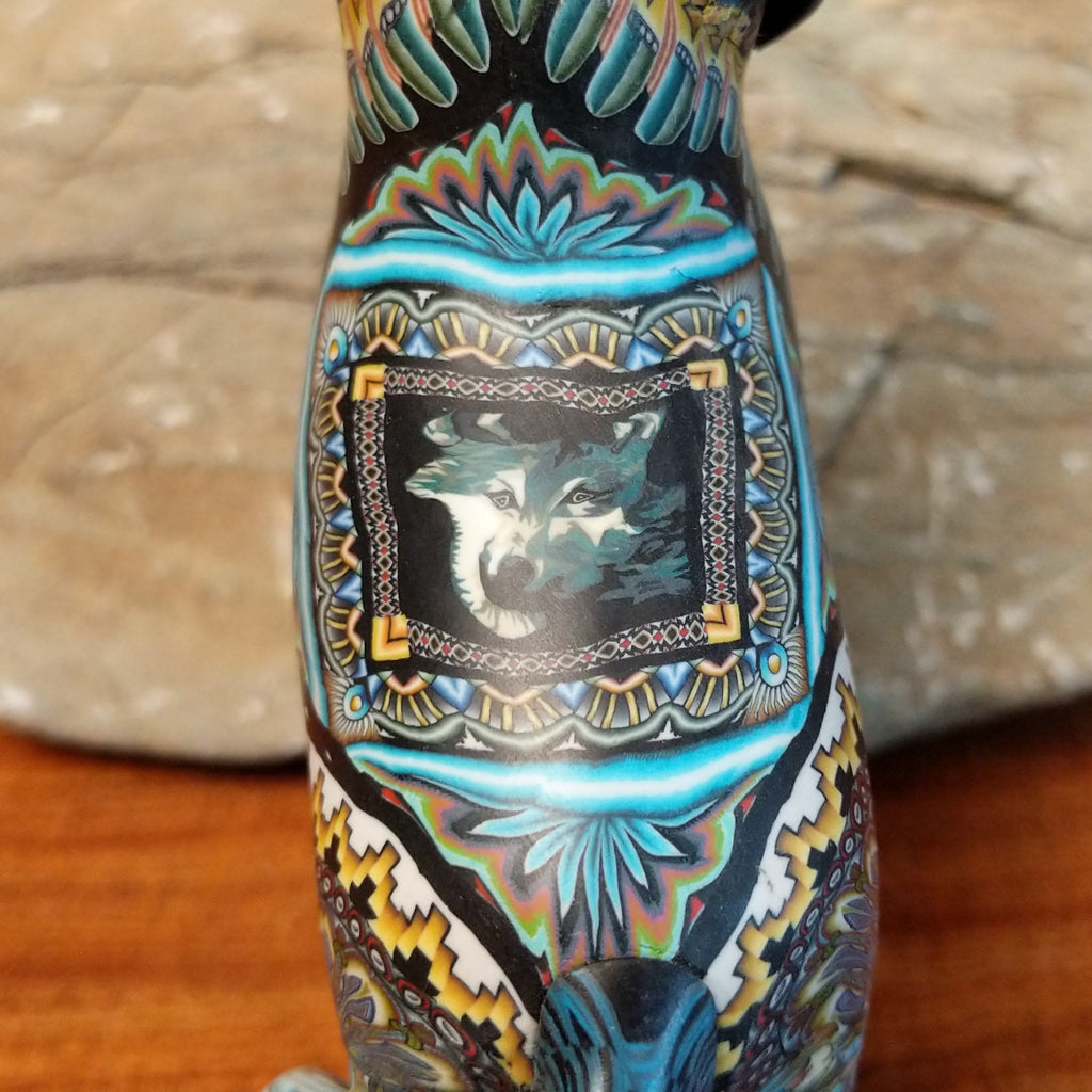 A close-up view of the detailed wolf face on the sculptures back.