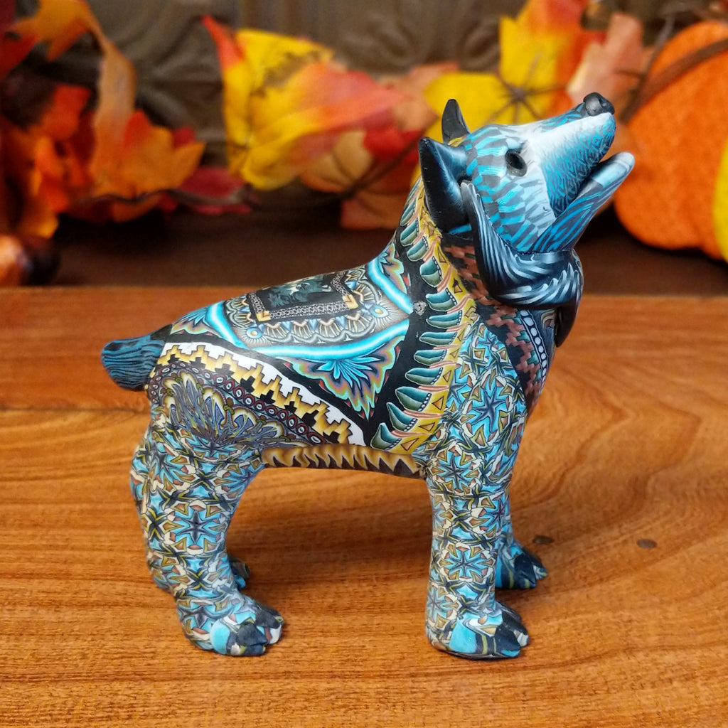 Polymer clay used to create a standing wolf with geometric and floral designs on its body.