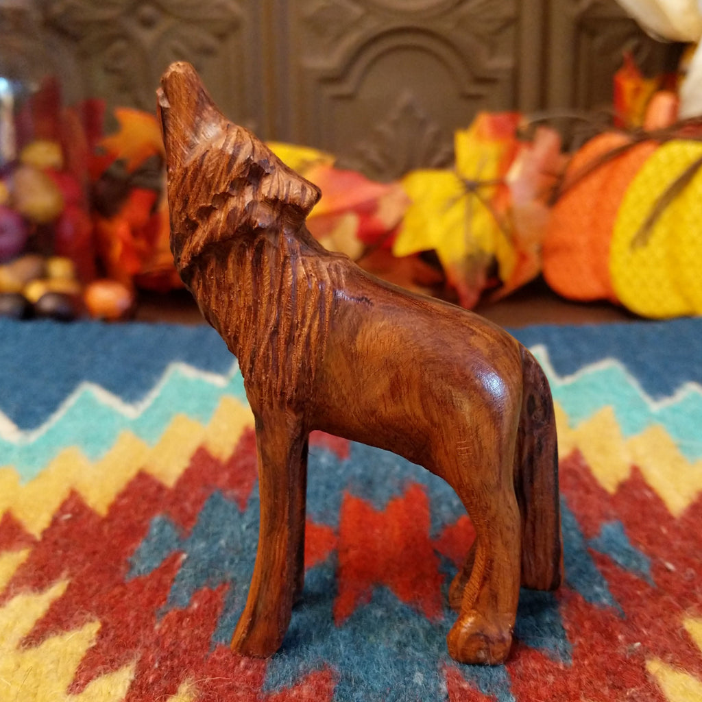 Ironwood carved into a howling wolf figurine.