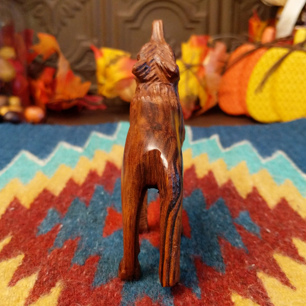 Ironwood carved into a howling wolf figurine.