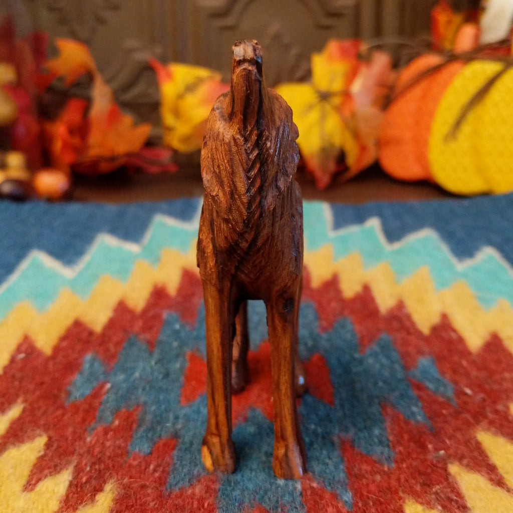 Ironwood carved into a howling wolf figurine.