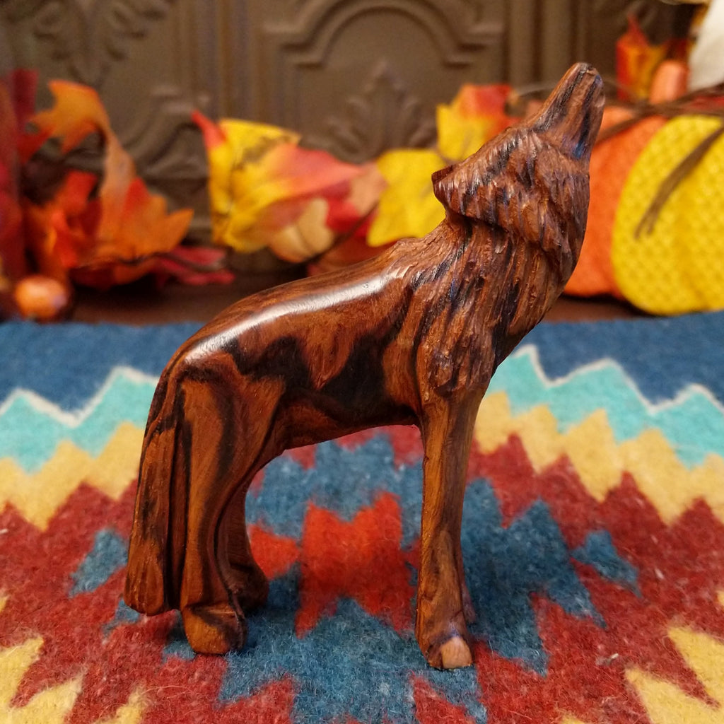 Ironwood carved into a howling wolf figurine.