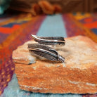 Wrapped Silver Feather Ring by Lena Platero with overlapping detailed feathers.