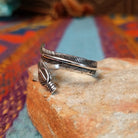 Wrapped Silver Feather Ring by Lena Platero with overlapping detailed feathers.