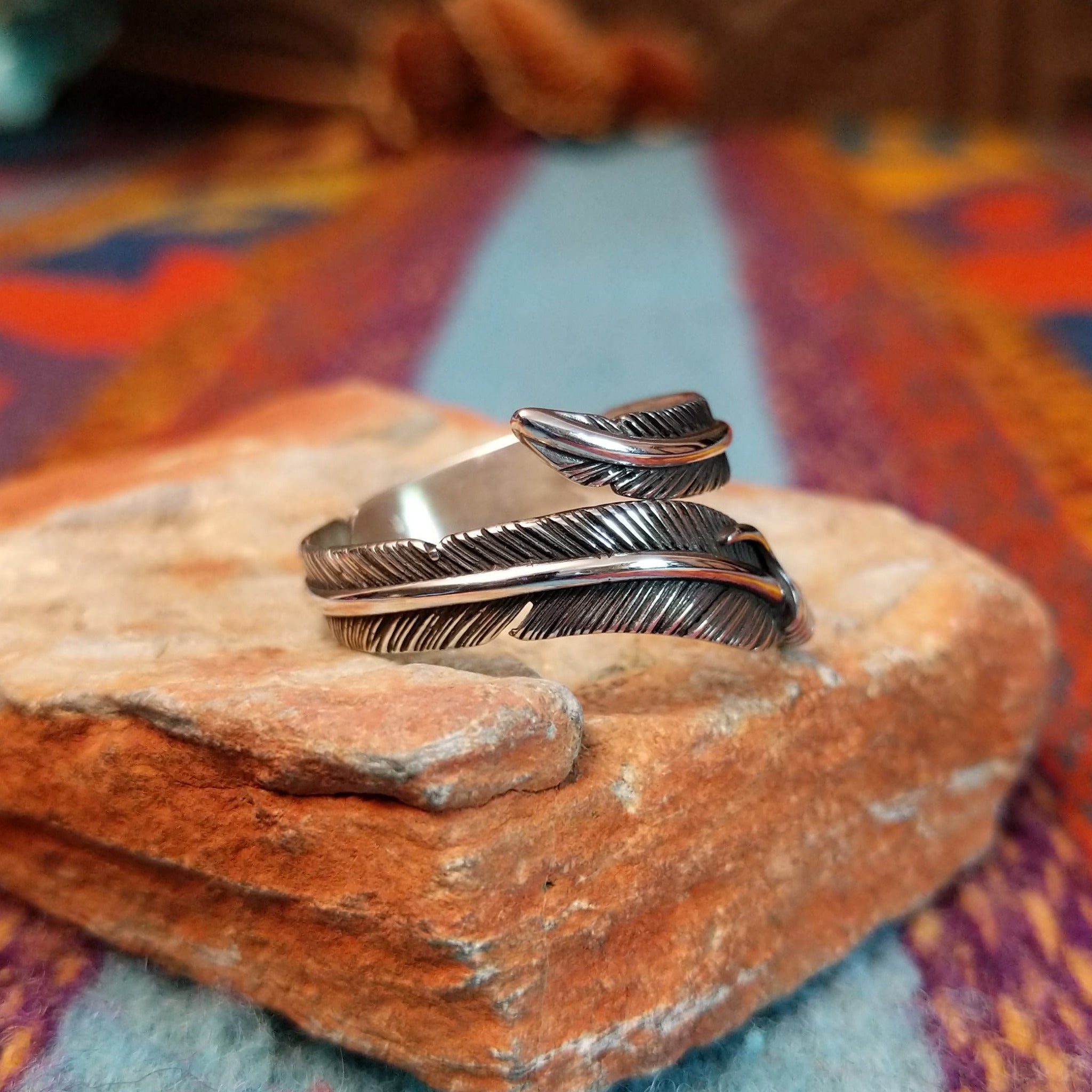 Wrapped Silver Feather Ring by Lena Platero with overlapping detailed feathers.
