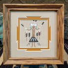 Framed Navajo sand painting of a Yei figure with raised arms. 