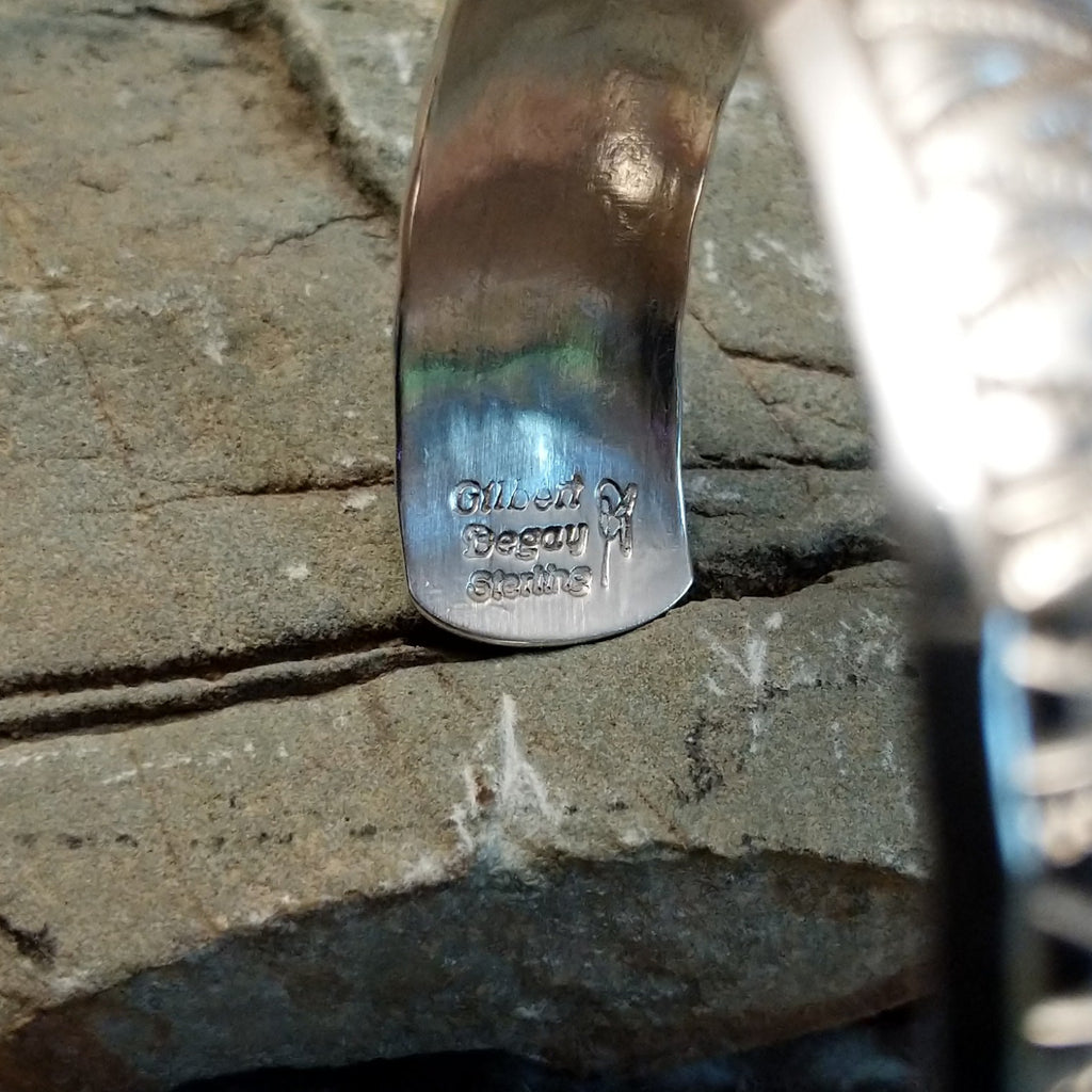 Close-up of the artisan's signature on the cuff.