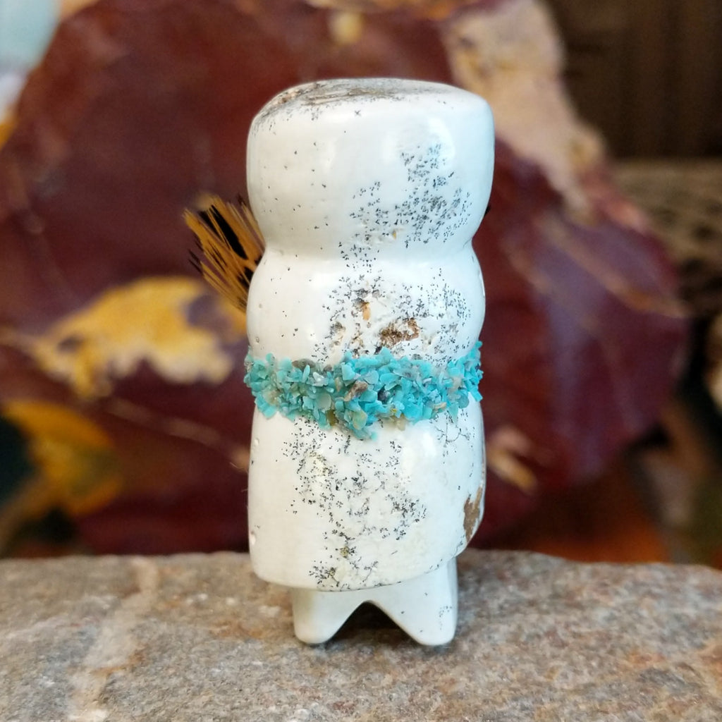 Serpentine carved into an altar doll fetish holding feathers, and turquoise clusters looping around the body.