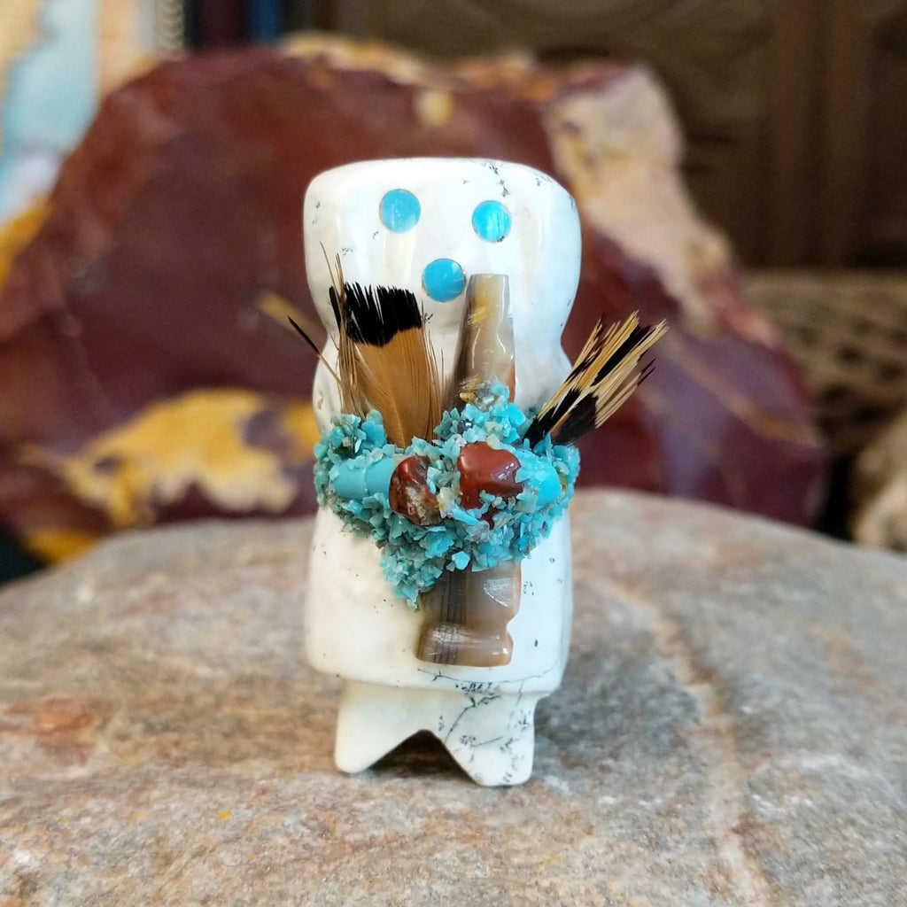 Serpentine carved into an altar doll fetish holding feathers, and turquoise clusters looping around the body.